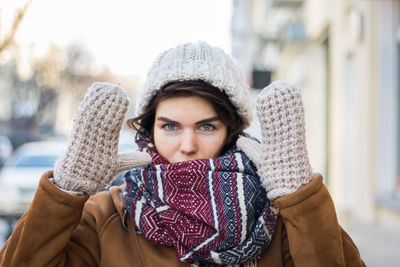 Portrait of young woman in city in winter