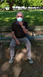 Man sitting on bench in park