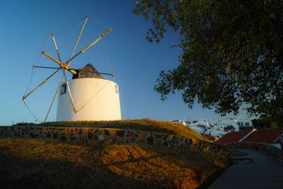 Low angle view of traditional windmill against sky