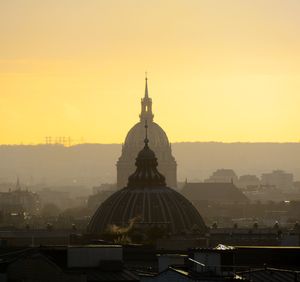 View of buildings in city at sunset