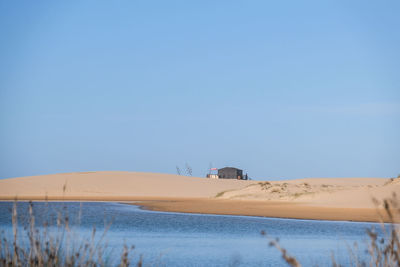 Scenic view of desert against clear blue sky