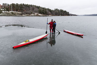 Man and woman paddle boarding