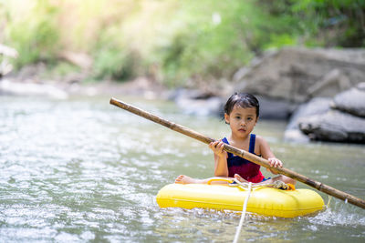 Active little girl playing at mountain stream