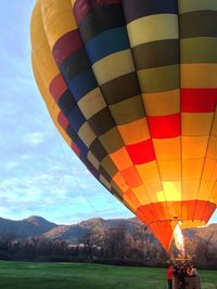 Hot air balloons on landscape against sky