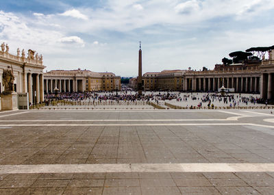 Group of people in front of historical building in city