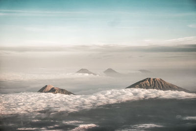 Scenic view of mountains against cloudy sky