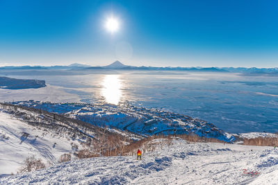 High angle view of person standing on snowcapped mountain