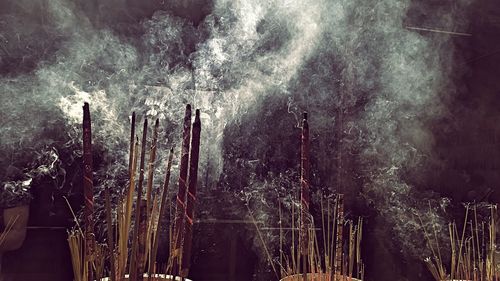 Smoke emitting from burning incense outdoors