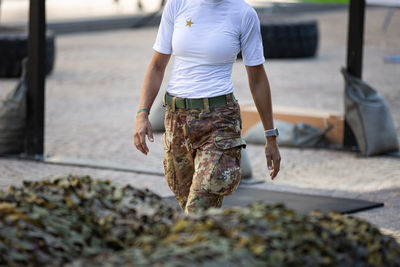 Detail of a soldier's legs- getting ready to do exercises with camouflage pants.