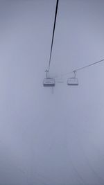 Overhead cable car against sky during winter