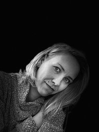 Portrait of a beautiful woman against black background