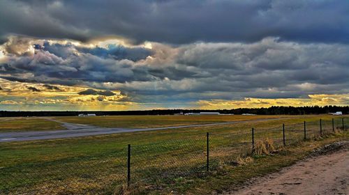 Scenic view of landscape against cloudy sky