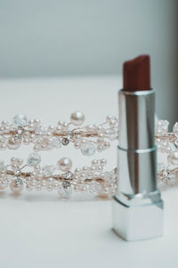 Close-up of glasses on table against white background