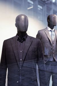 Midsection of businessman standing against wall