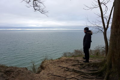 Man looking at sea against sky