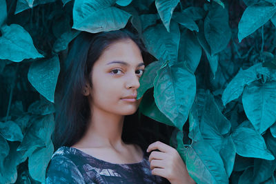 Portrait of teenage girl by leaves