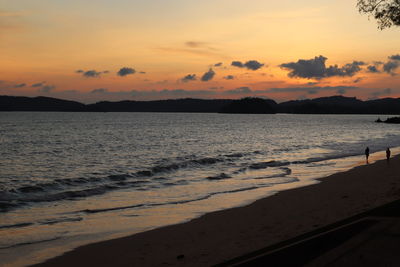Scenic view of beach against sky during sunset