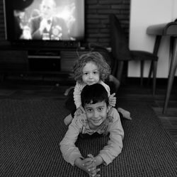 Portrait of smiling girl and boy at home