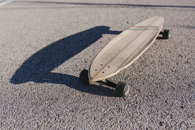 Isolated longboard in the asphalt