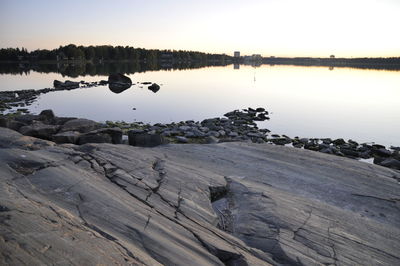 Scenic view of lake against sky at sunset
