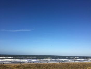 Scenic view of sea against clear blue sky