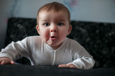 Close-up portrait of baby boy on table