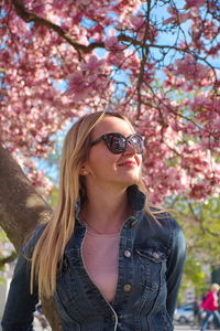 Woman wearing sunglasses standing in park