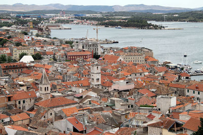 High angle view of townscape by sea