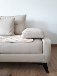 Empty chair against white wall at home