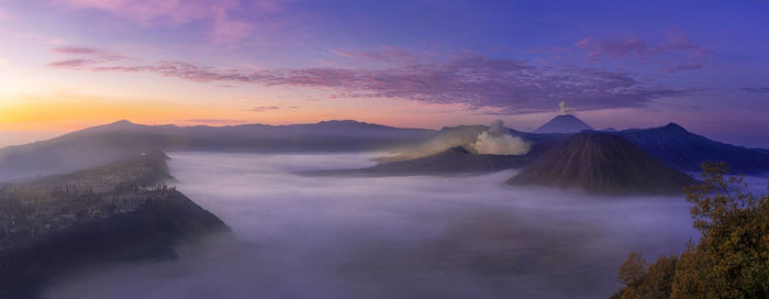 Scenic view of mountains against sky at sunset