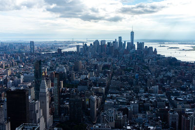 Aerial view of modern buildings in city against sky