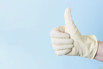 Close-up of human hand against clear sky