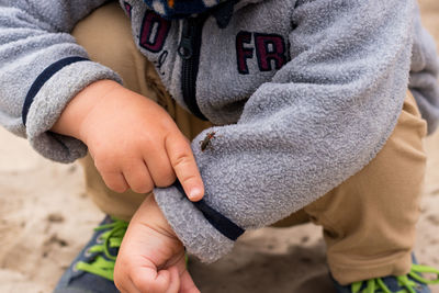 Midsection of child holding hands