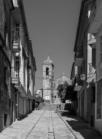 Street amidst buildings against sky in city