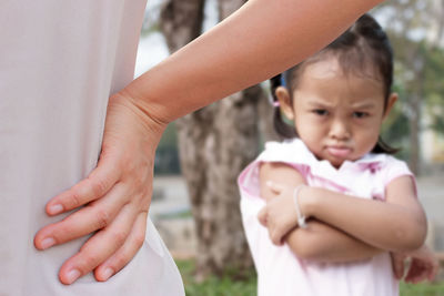 Portrait of girl with mother outdoors