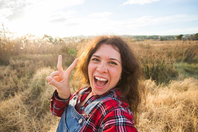 Portrait of smiling young woman on field