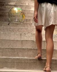 Low section of woman standing on tiled floor