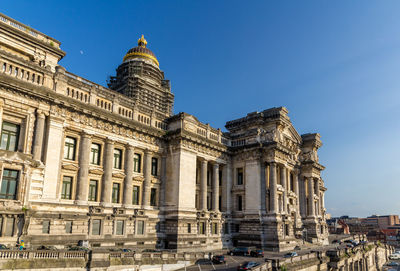 Low angle view of historical building against blue sky