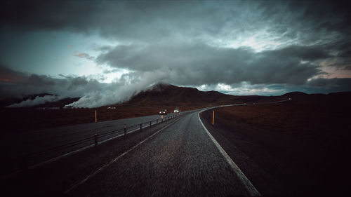 View of empty road against cloudy sky