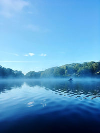 Scenic view of lake against blue sky