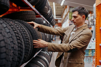 Man choosing tire at store