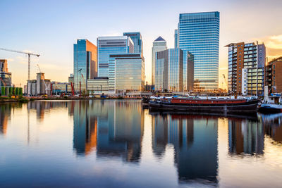 Canary wharf cityscape, financial hub in london at sunset viewed from blackwall basin