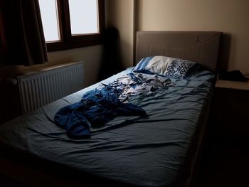 High angle view of messy bed at home