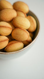 Close-up of pills in bowl on white background