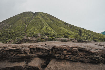 Low angle view of rocks against clear sky