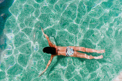 High angle view of woman swimming in pool