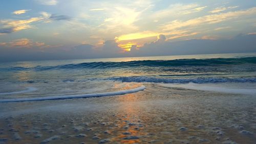 Scenic view of sea against cloudy sky