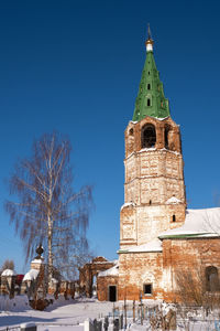 Low angle view of tower of building against blue sky