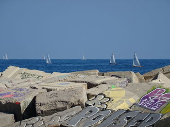 Scenic view of beach against clear blue sky