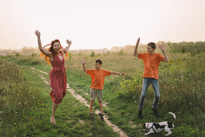 Happy mother having fun with her two sons outdoors.